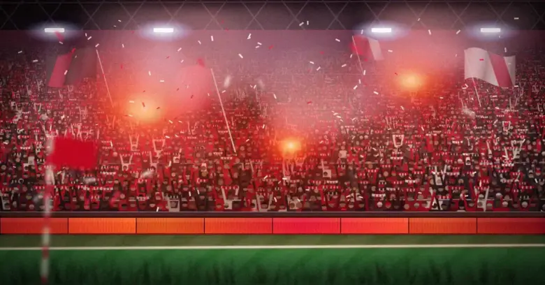 Täpötäysi jalkapallostadionin seisomakatsomo, jossa punamustiin pukeutuneet kannattajat nostavat huivejaan ja heiluttavat lippuja soihtujen punaisessa savussa ja valonheittimien valossa.
